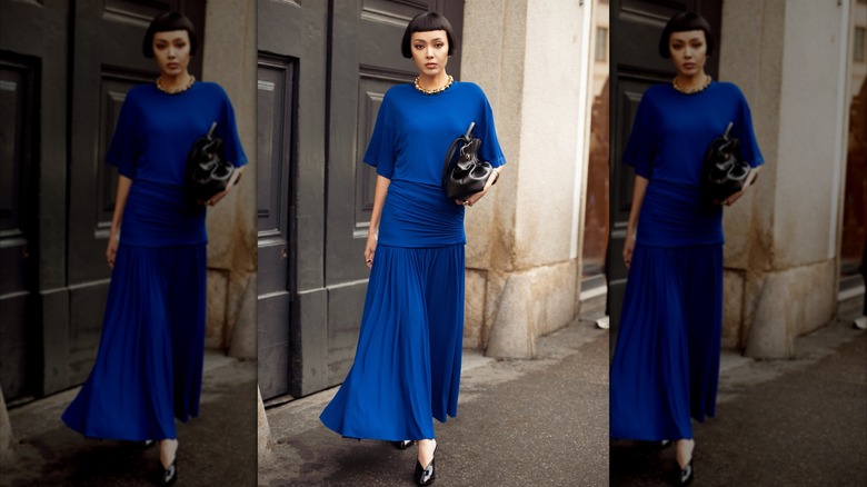 A woman in a blue draped dress