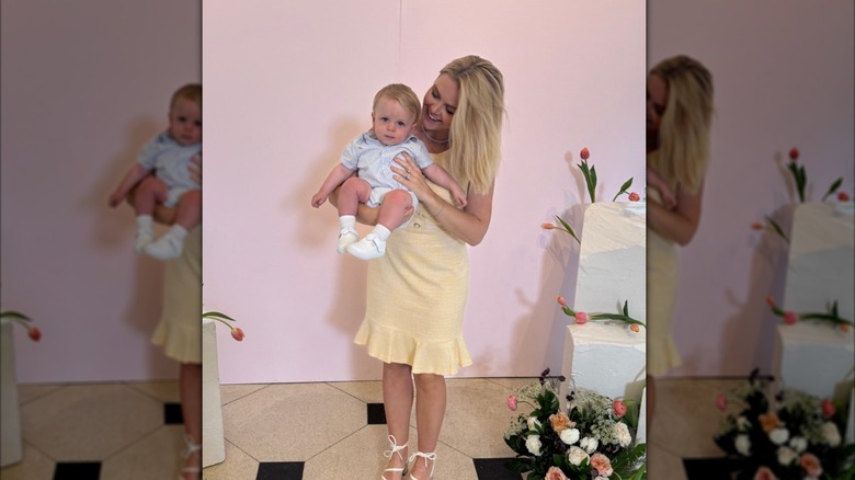Karoline Leavitt in a yellow dress holding her son