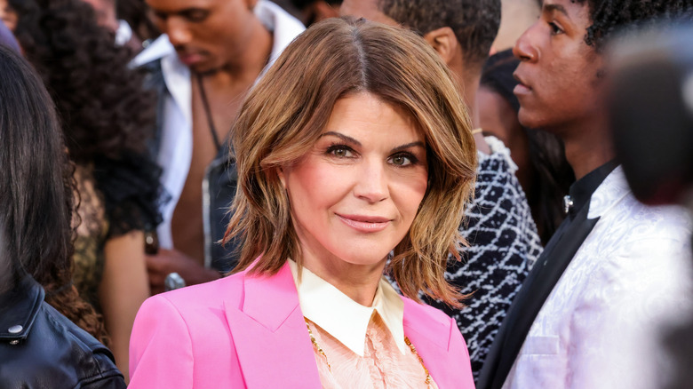 Lori Loughlin at an event, wearing a pink suit jacket