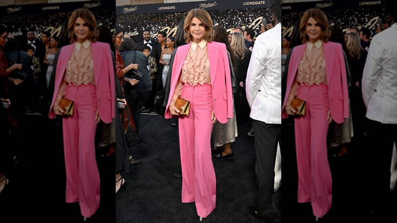 Lori Loughlin posing on the red carpet in 2026, wearing a pink pantsuit