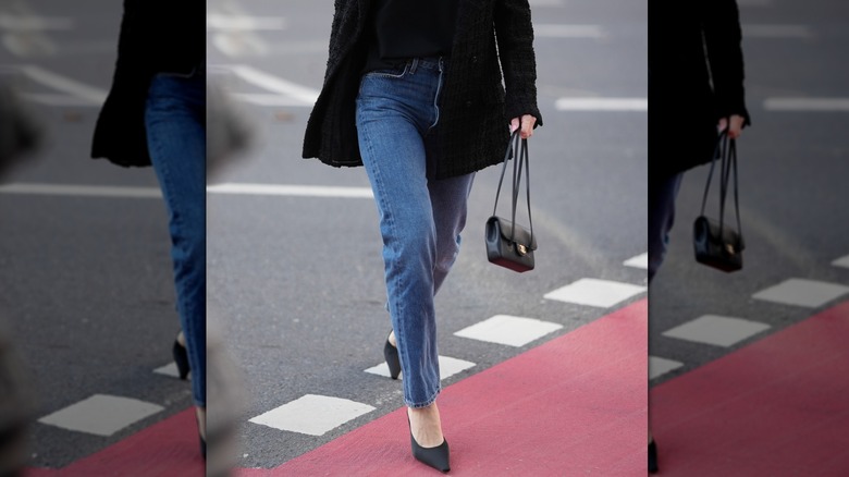 Woman crossing the street in straight-leg jeans
