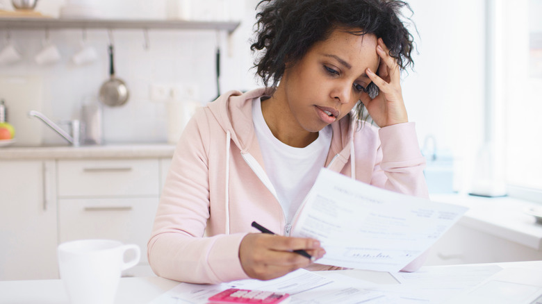 woman looks at finances