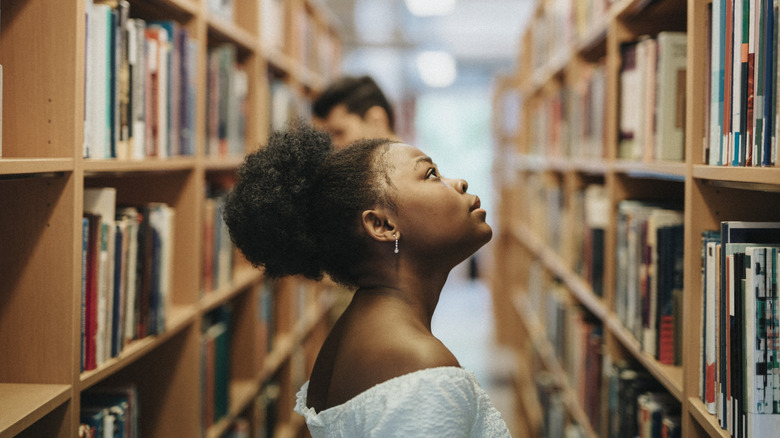 Woman looking at bookshelves
