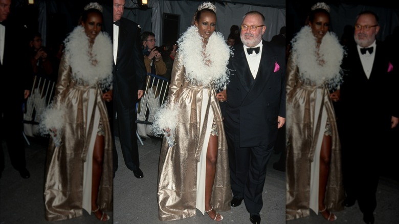 Iman at the 1997 Met Gala in a gold coat and tiara
