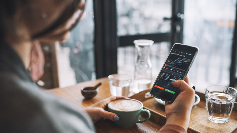 Woman looking at stocks on her phone
