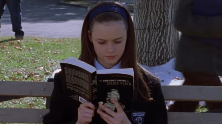Rory Gilmore reading Syivia Plath on a bench