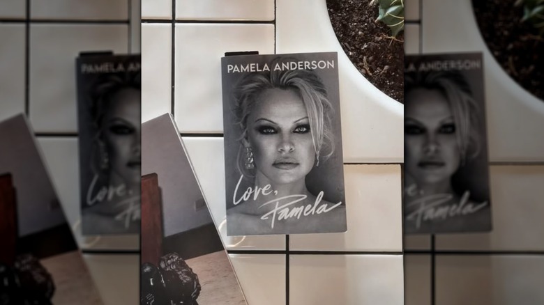 A copy of "Love, Pamela" sitting on white tile