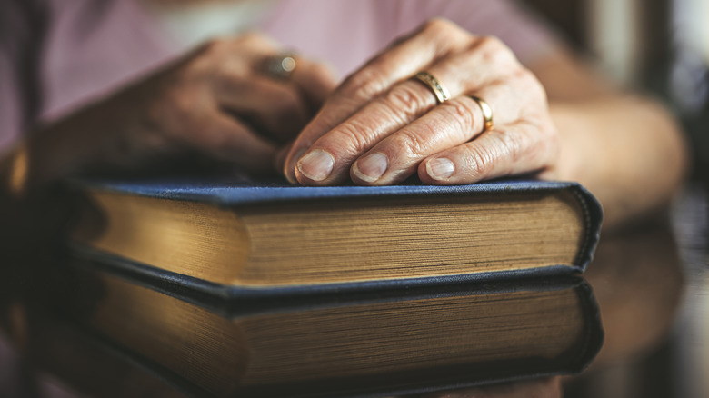 Woman's hand on a book