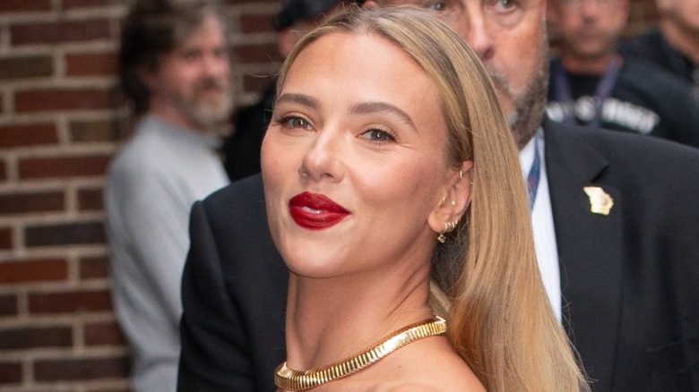 Scarlett Johansson smiling and wearing red lipstick