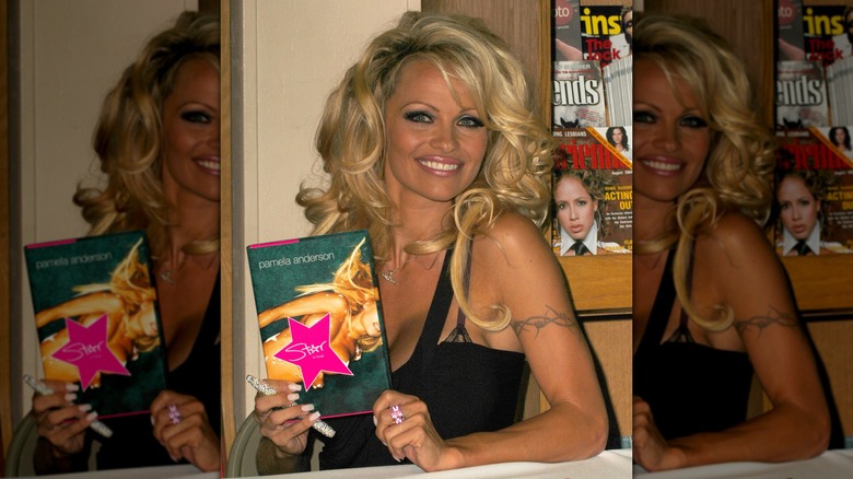 Pamela Anderson holding a copy of her book, Star