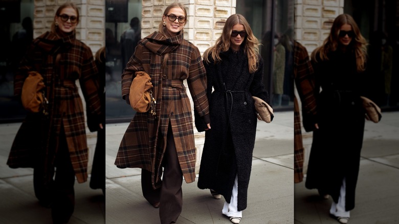 Two women walking with one in a brown plaid coat