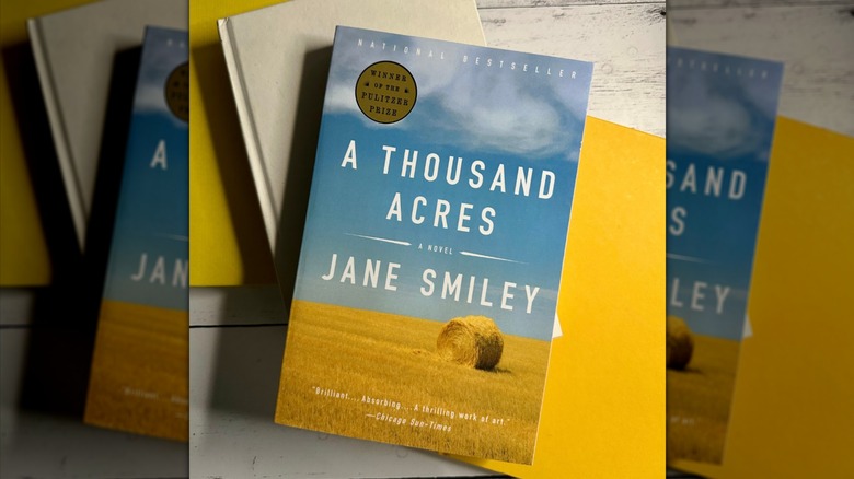 A copy of "A Thousand Acres" resting on top of some other books