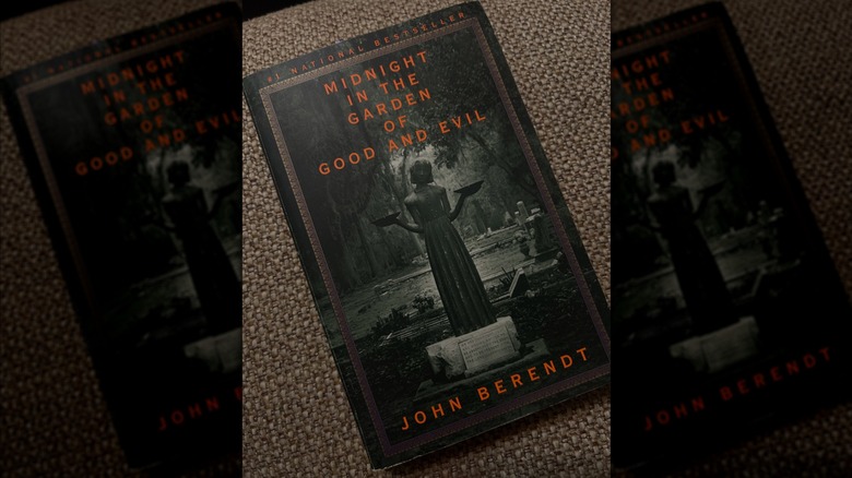 A copy of "Midnight in the Garden of Good and Evil" resting on a cushion
