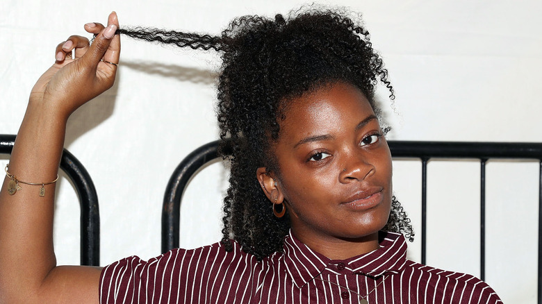 Ari Lennox playing with her curls