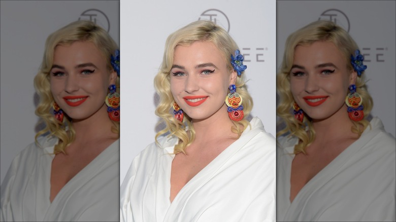 Woman with side part and hair pinned back