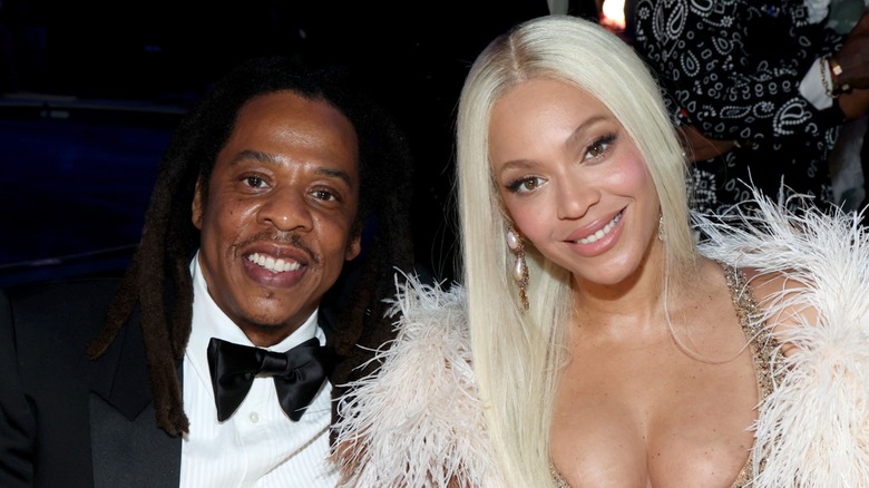 Jay-Z and Beyoncé smiling side by side at an event