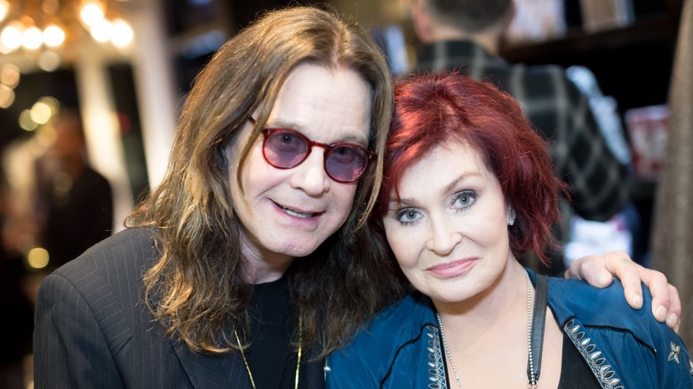 Ozzy Osbourne with his arm around Sharon Osbourne