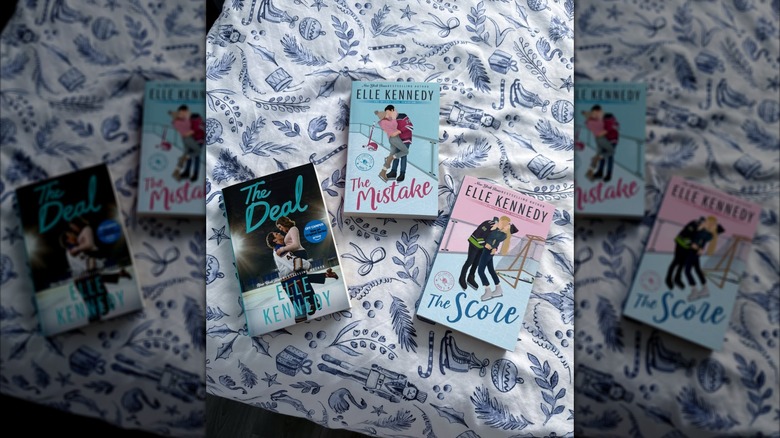The books from the Off-Campus series laying on a patterned sheet