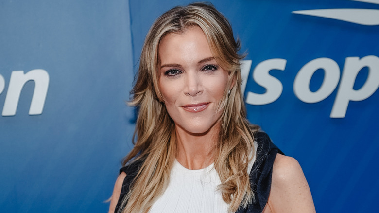 Megyn Kelly with shoulder length hair in front of a step and repeat