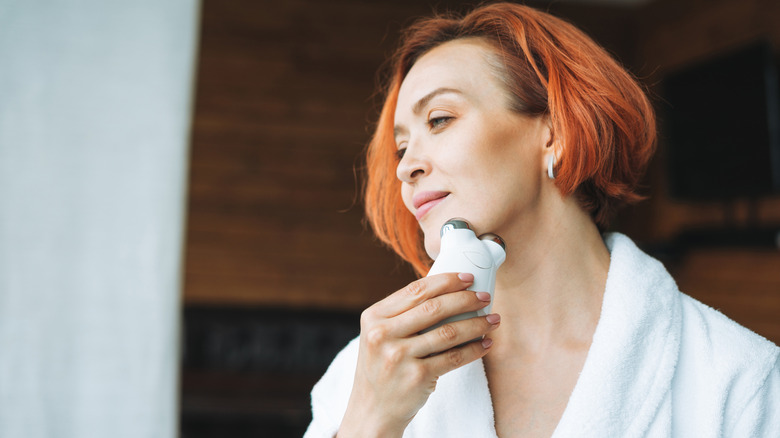 A woman using a facial device