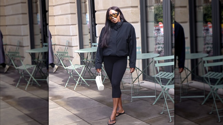 Woman wears black capri leggings