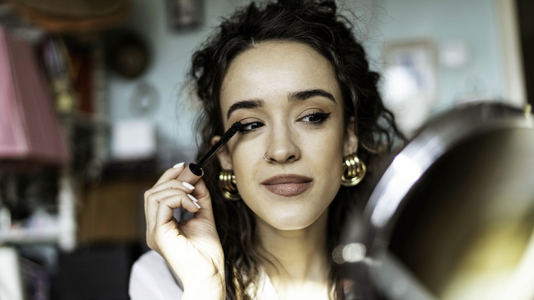 Woman applying makeup