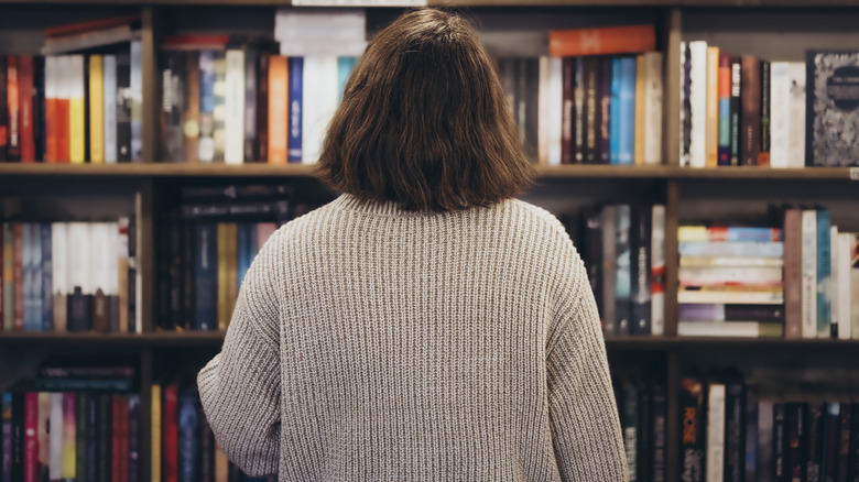 Woman looking at bookshelf