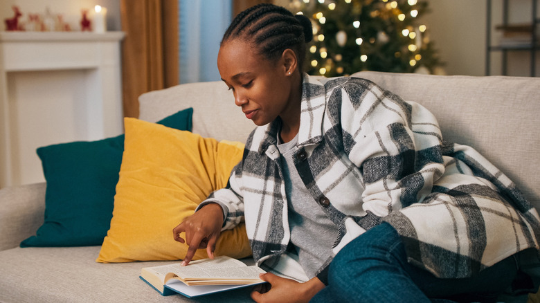A woman enjoys a book in the winter