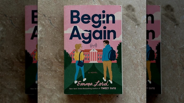 A copy of "Begin Again" laying on a concrete floor