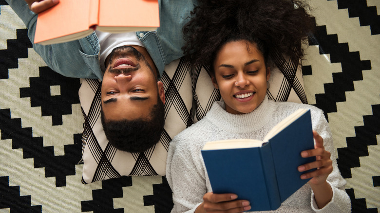 Young couple on the floor reading