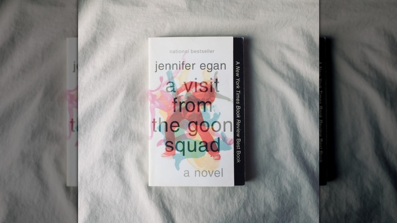 A copy of "A Visit from the Good Squad" laying on a white sheet