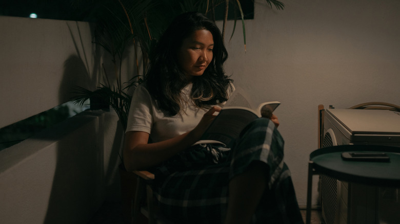 A woman reading in the dark