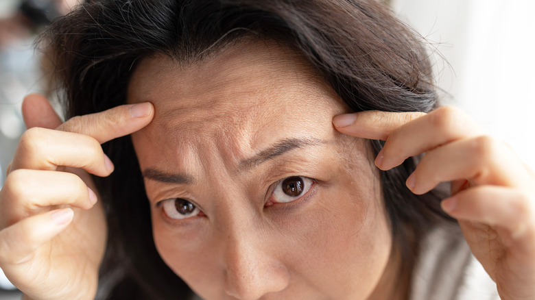 women furrowing her brow whlist looking forward