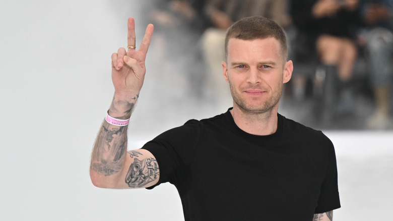 Matthew Williams giving the peace sign in a black shirt