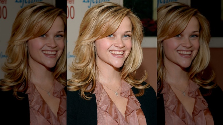 Reese Witherspoon smiling at a Lifetime event with layered, side bangs