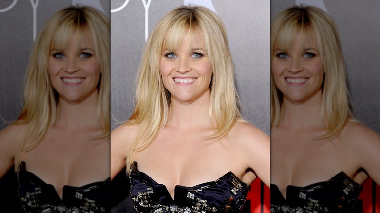 Reese Witherspoon smiling at a 2012 premiere with choppy bangs