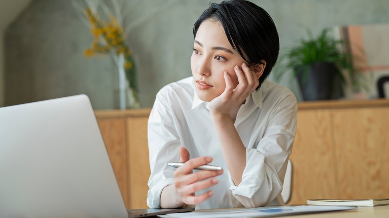 Person thinking at desk