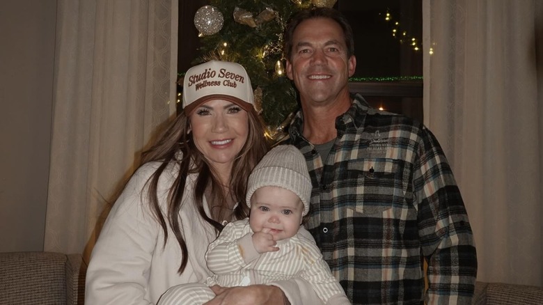 Kristi Noem and Bryon Noem next to a Christmas tree