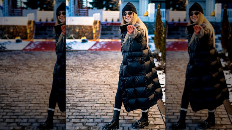 A woman in a long puffer coat