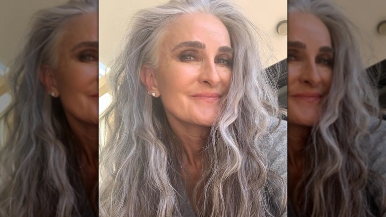 A woman with long, gray hair in its natural texture