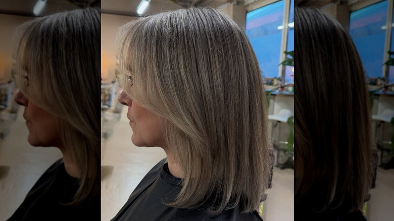 A woman with a straight, gray-blended lob