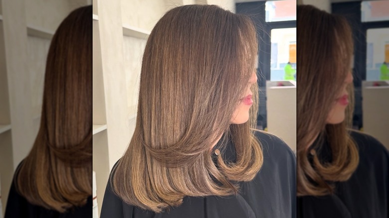 A woman with mid-length hair in a subtle ombré