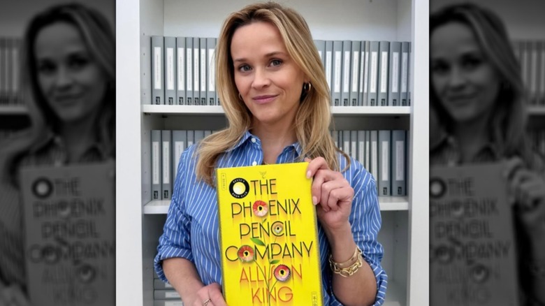 Reese Witherspoon holding "The Phoenix Pencil Company" by Allison King in June 2025
