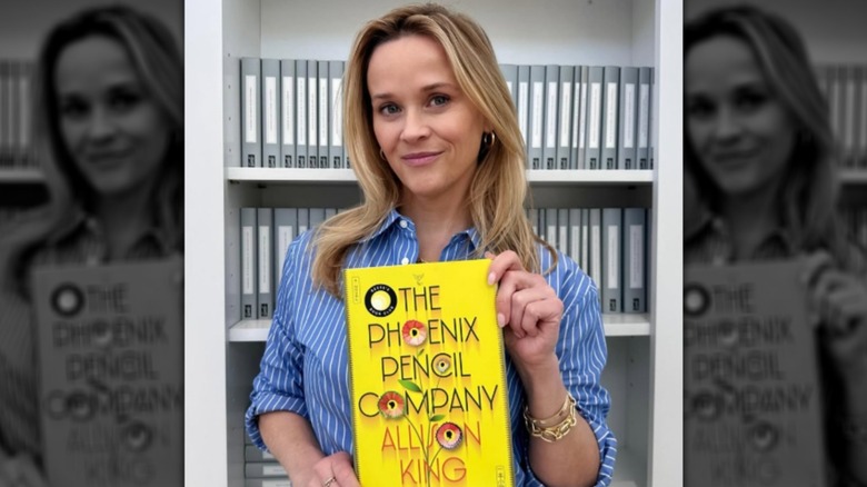 Reese Witherspoon holding "The Phoenix Pencil Company" by Allison King in June 2025