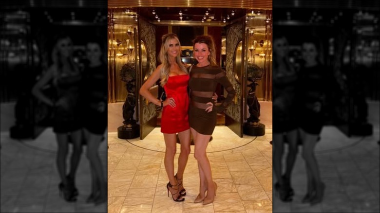 Christina Haack in a satin red dress standing with a friend in July 2024