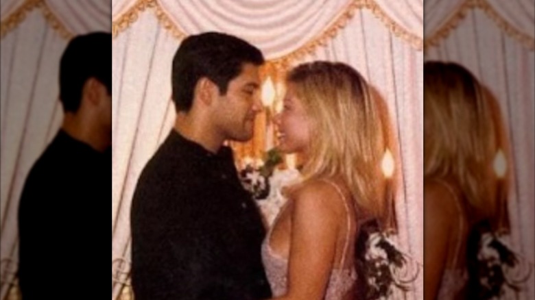 Kelly Ripa in a white dress and Mark Consuelo stood in a black suit