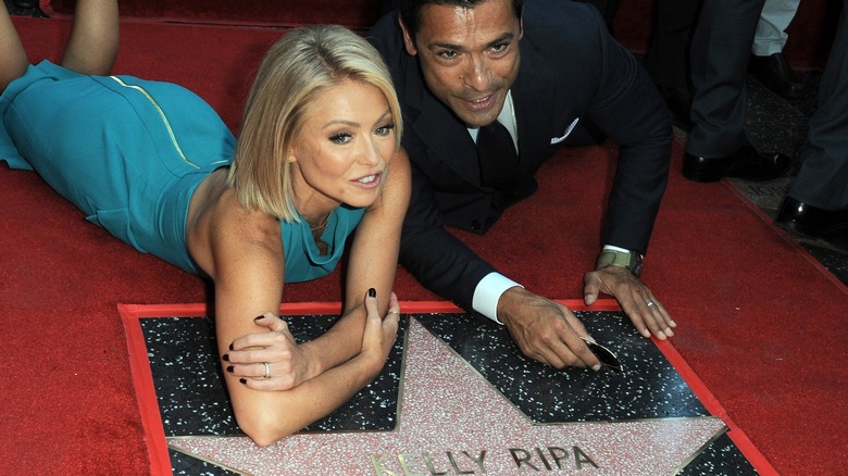 Kelly Ripa and Mark Consuelos laying on her Hollywood Walk of Fame star