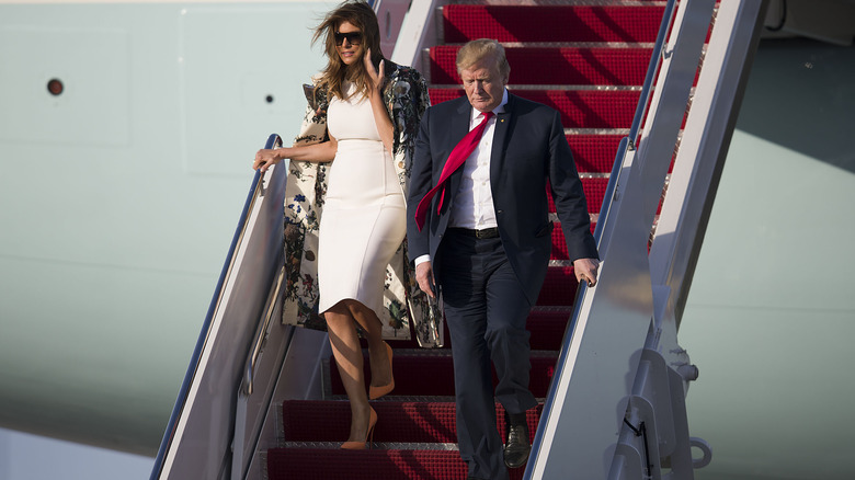 Melania and Donald Trump descending the steps of Air Force One