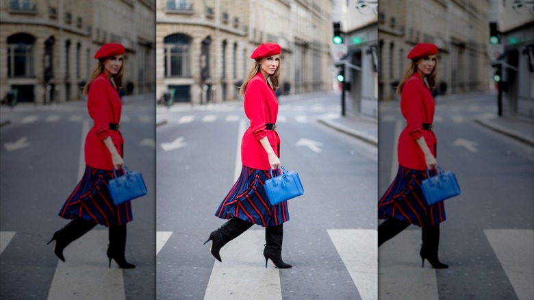 A colorfully dressed older woman walking in the street