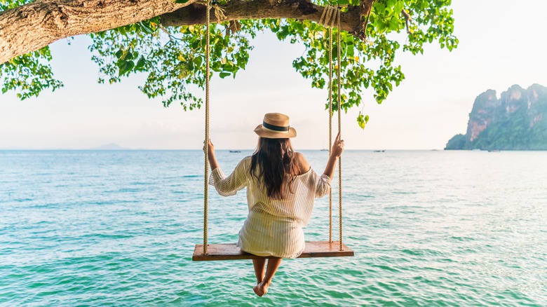 Woman on swing over water